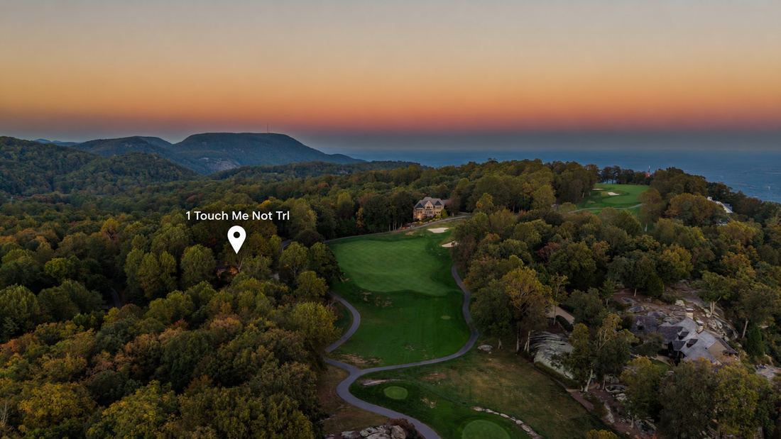 Aerial, the course and the mountains beyond (location marked)